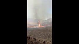 Dust devil swirls FIRE into air as blaze burns Indonesian mountain