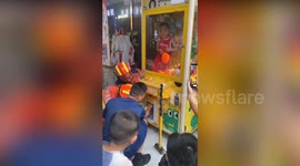 Firemen rescue boy, 5, who climbed into claw grabber machine to get the toys