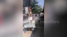 Policeman douses electrical transformer that burst into flames with fire extinguisher