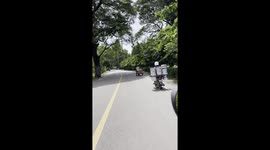Motorcycle rider carries 12 buckets on the back of his bike