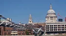 Business people queue on the Millennium Bridge in London to pressure UK government on climate policies