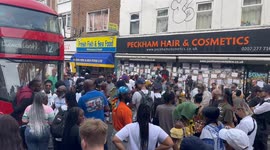 Protesters are seen outside Peckham Hair and Cosmetics during the demonstration.
