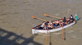 The Great River Race with 300 participant rowing boats powers past Westminster Bridge