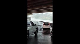 Foolish motorist becomes trapped in truck after trying to drive through deep floodwater