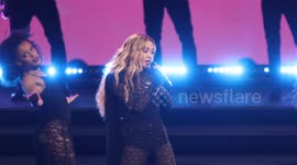 Harry and Meghan high-five performers during Rita Ora's performance at Invictus Games