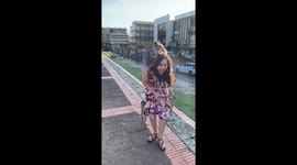 Monkeys climb all over woman in red dress in Thailand