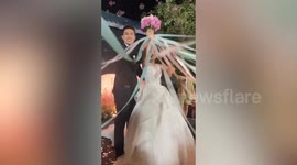 Bride plunges from stage when excited guests race to pull flower bouquet from her