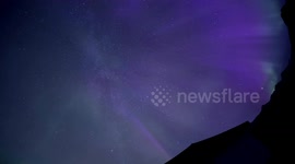 Stargazer over the moon after capturing meteor soar through aurora in Iceland