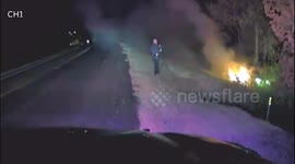 US police officer pulls driver out of burning car in dramatic rescue