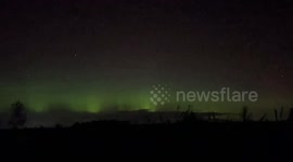 Northern lights flicker in sky over town in Canada