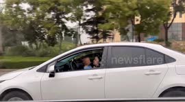 Mother in China shockingly caught holding baby while driving