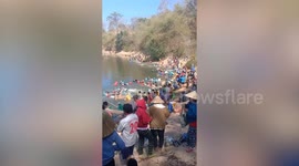 Locals converge on river with nets and hooks to catch fish
