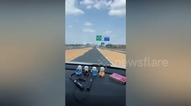 Farmers cover road in grain to dry in the sun in China