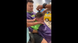 Toddler cries inconsolably while having his second-ever haircut