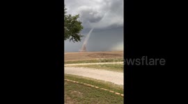 Dust cloud forms as landspout swirls over fields in Kansas