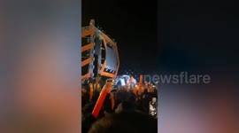 Cameraman slips off stage while recording concert in Cambodia