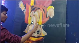 A Young Indian Artist make opposite God Ganesh drawing on occasion of Ganesh chaturthi in Ordisha
