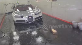 Bugatti Veyron worth a staggering 2.7 million pounds and has a silver reflective paint job