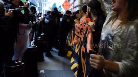 Climate protesters block the doors to the Federal Reserve Bank of New York
