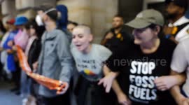 Climate protesters block the doors to the Federal Reserve Bank of New York