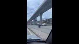 Motorcycle rider carries second bike strapped to the back of his own