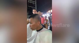 Barber shaves awesome portrait haircut onto the back of his own head
