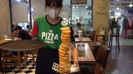 Try an onion ring tower covered with hot melter cheese at this Thai pizza joint