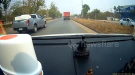 Truck nudges road barriers that spin into oncoming car