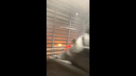 Commuters run from rain as storm batters monorail station in Bangkok