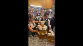 Oktoberfest waitress effortlessly carries 13 huge beers at once