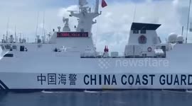 Chinese Coast Guard flash LED warning sign as they block Philippine vessel from entering disputed waters