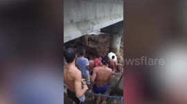 Woman stranded on bridge pier rescued as flash flood surges