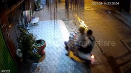Bungling pillion passenger falls into lotus pond while climbing down motorcycle