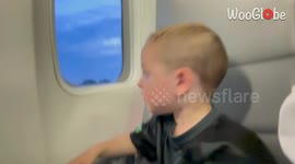 Boy's excitement encounters turbulence as the plane gets ready for takeoff!