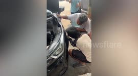 Kind residents rescue kitten trapped under car's engine