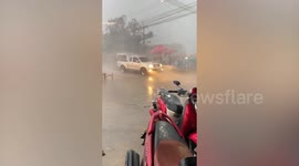 Vendors battle to hold down stalls as storm hits market in central Thailand