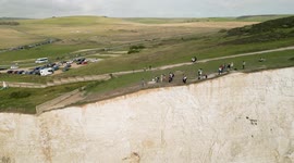Tourists sit precariously close to crumbling cliffs at Birling Gap despite coastguard warnings