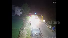 Truck strikes height restriction bar, launching it at roadside worker in China