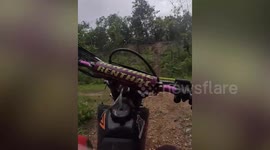 Off-road scrambler catches fire during muddy race in Thailand