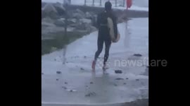 Crazy surfer goes out in Storm Agnes as it batters the North Wales coast