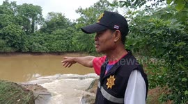 Footbridge collapses as heavy rain batters aging weir in Thailand