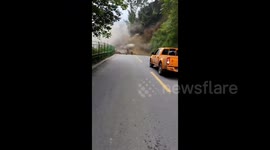 Truck reverses to escape mountainside collapse in southern China