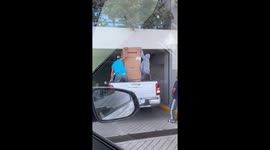 Bungling deliverymen get fridge stuck in building entrance