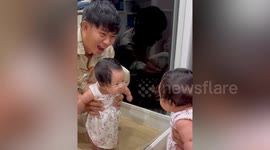 Baby looks delighted seeing her reflection in mirror for first time