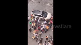 Crowd unites to free girl trapped underneath car in southwest China