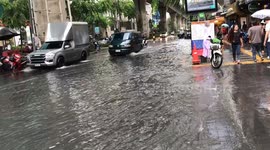 Heavy rain and storm in central Bangkok, 25th September 2023. Cars risk the floodwaters to get where they need to be.
