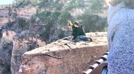 Tourists Hop Over Railing at Grand Canyon