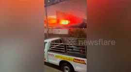 Electric transformer explodes in market during storm in Thailand