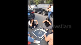 Stranded drivers play mahjong on highway on first day of dual festivals in China