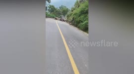 Rocks crash down mountain narrowly missing cars in China